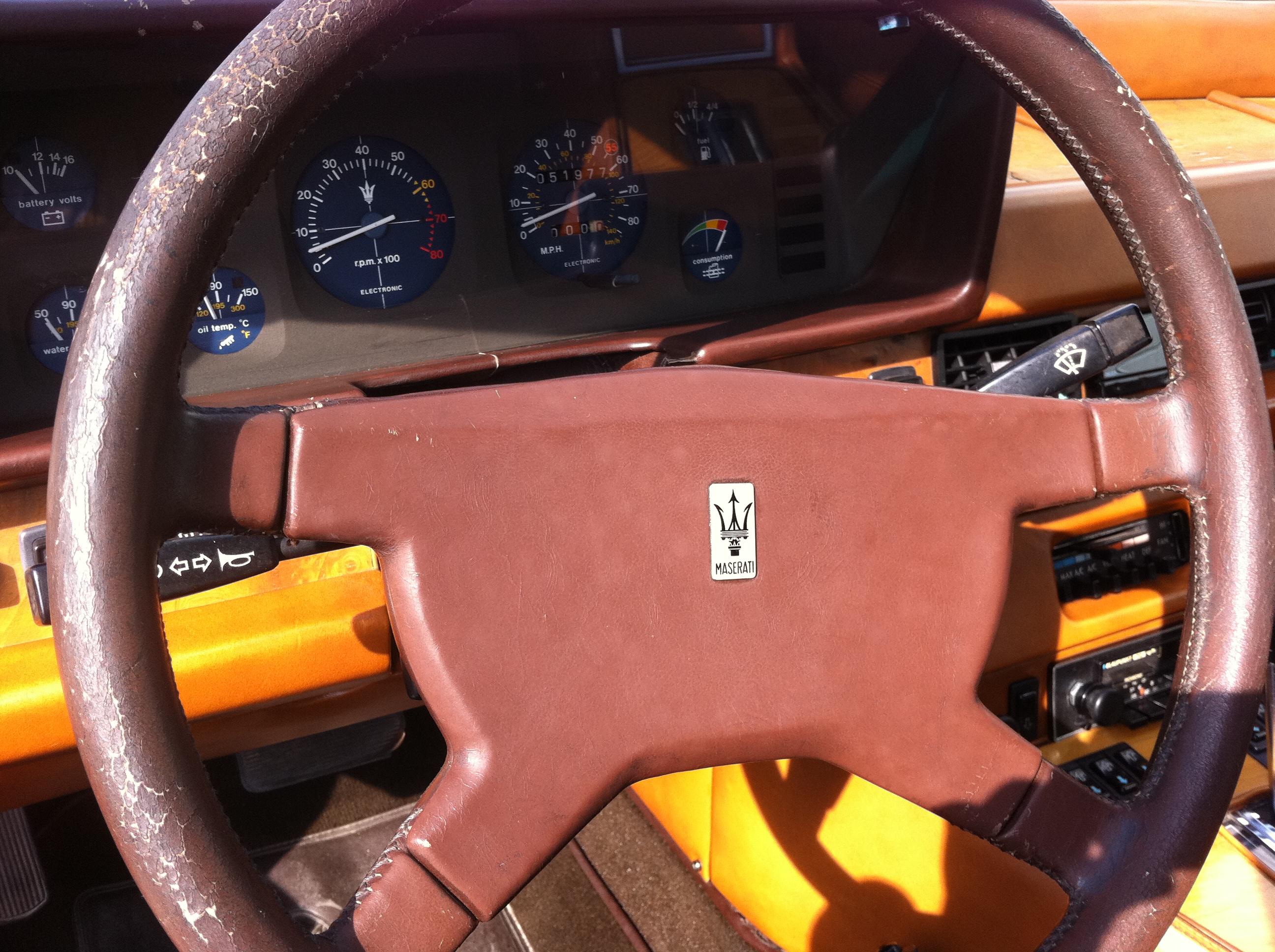 Original steering wheel. Leather baked and cracked all around.