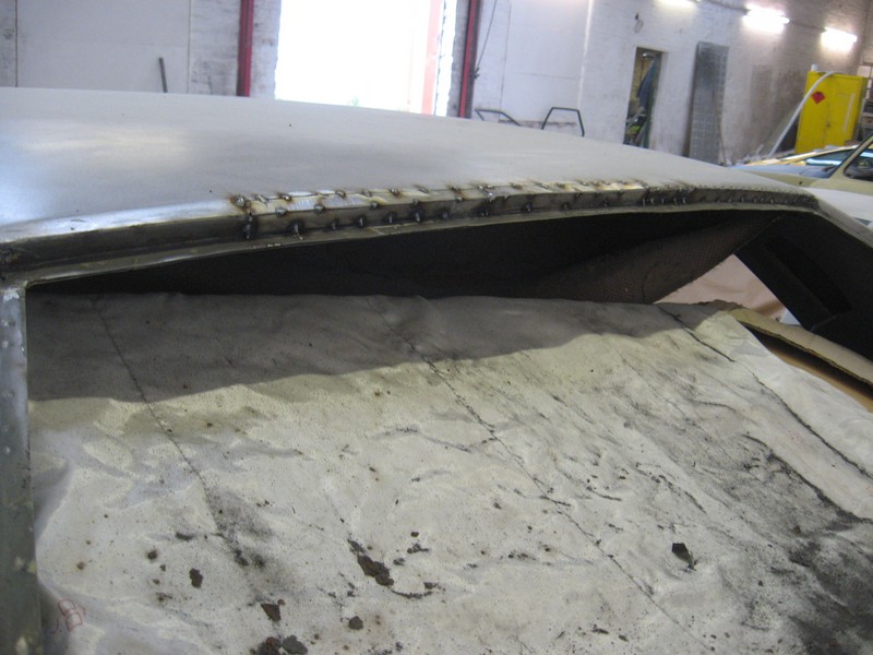 Rear window top edge tack welded in